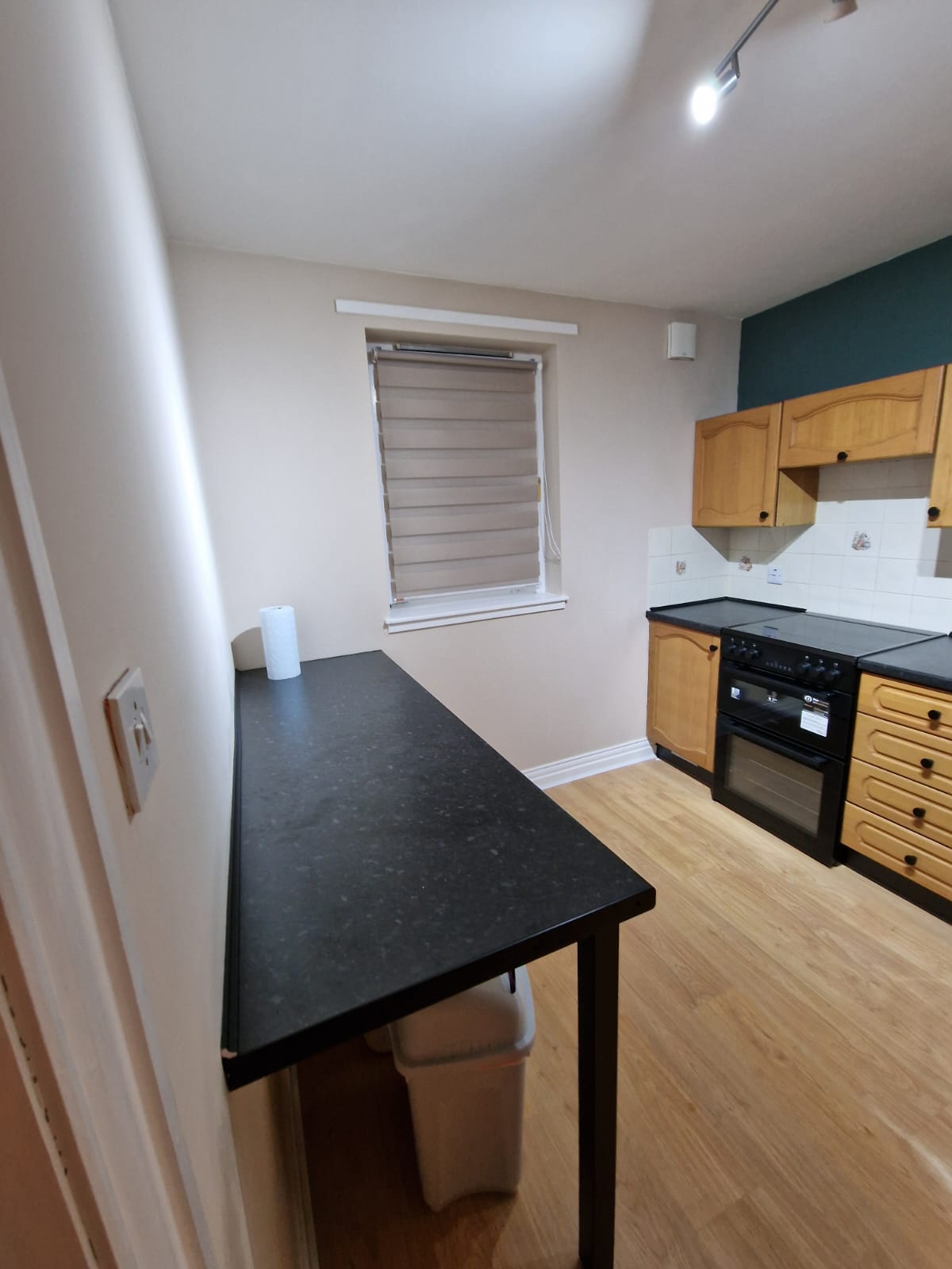 Kitchen view towards the window, extra worktop and cooker